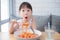 Girl enjoy eating spaghetti on table at restaurant