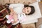 Girl enjoy evening time with favorite toy. Kid lay bed and hug bunny toy couch pillow blanket background top view. Girl