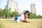 Girl enjoy reading a book laying on grass of park