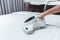 Girl enjoy using mite vacuum cleaner using cleaning bed mattress