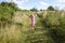 Girl enjoying freedom while playing in green spring rural meadows