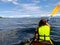 A girl enjoying kayaking on the beautiful and calm ocean waters in the Gulf Islands, outside Newcastle Island near Nanaimo