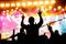 Girl enjoying a music festival or concert. Black silhouette of the crowd