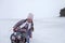 Girl enjoying a sleigh ride on the frozen lake, winter, silence and wild nature, lifestyle