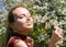 Girl enjoying smell of cherry blossoms