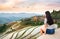 Girl enjoying sunset at terraced rice field in Longji, China