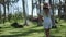 Girl enjoying the walk among tropical palms