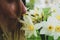 Girl enjoys the aroma of a bouquet of daffodils