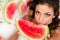 Girl enjoys a bath with milk and watermelon.