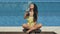 girl enjoys blue cocktail with basil seeds near pool, slowmotion