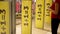 Girl entering shop. Three big yellow sales promotion signs on shop entrance magnetic gates. Consumerism concept