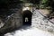 The girl enters the tunnel. Tunnel under the railway