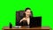Girl enthusiastically works behind a laptop, smiles and enjoys the result. Green screen