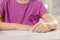 Girl erasing mistake in her homework at white desk, closeup