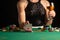 Girl in evening dress plays poker draws a card in a casino. focus on the card and focus