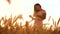 Girl evening is standing in in the wheat field nature slow motion video. beautiful girl in white dress running hands to