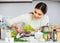 Girl eviscerating salmon fish in domestic kitchen