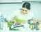 Girl eviscerating salmon fish in domestic kitchen