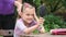 Girl examines himself in mirror while combing her mom