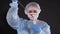 Girl examines a test tube with biomaterial. Young woman in protective clothing. On the face of a protective medical mask