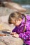 Girl Examining Beach Pebble