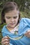 Girl Examining Caterpillar On Leaf