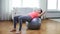 Girl exercising with fitness ball at home