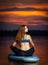 Girl exercising yoga on paddleboard in the sunset on scenic lake Velke Darko