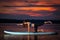 Girl exercising yoga on paddleboard in the sunset on scenic lake Velke Darko