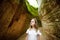 Girl exploring Etruscan Le Vie Cave Via Cava, the path connecting ancient necropolis and settlements in the area between Sovana