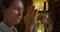 Girl face close-up prays in the temple. Woman prying hands in worship to God in church.