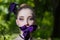 Girl with fancy creative make-up holding iris flower in mouth