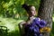 Girl with fancy creative make-up holding iris flowers bouquet