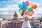 Girl, fashion model with balloons in a waved dress on the background of St. Petersburg, Russia. Kazan Cathedral