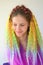 A girl with a fashionable set of multicolored braids Kanekalon. Colored artificial strands of hair.