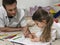 Girl And Father Coloring Book Together On Floor