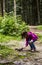 A girl feeding a carpathian squirell in the forest, Skole Beskids National Nature Park, Ukraine