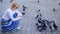 Girl feeding dove birds. Group doves on city square waiting treats. Share generosity. Girl blonde woman relaxing city