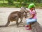 Girl feeding kangaroo