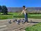 A girl feeding pigeons with breadcrumbs on the wooden waterfront