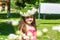 Girl in a field of camomiles catching a butterfly