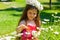 Girl in a field of camomiles catching a butterfly