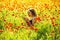 Girl in field of poppy making selfie photo with phone