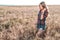 Girl in a field shirt shorts, wheat outdoor recreation, beautiful hair. A student walks after school.