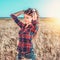 Girl in a field shirt shorts, wheat outdoor recreation, beautiful hair. A student walks after school. The woman`s long