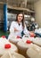 girl filling bottles with olive oil