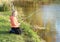 Girl fishing on pond