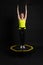 Girl on a fitness trampoline on a black background in a yellow t-shirt black energy woman, fun exercise caucasian health