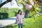 Girl fixes her hair under the sakura tree.