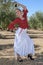 Girl in a flamenco position in an olive grove